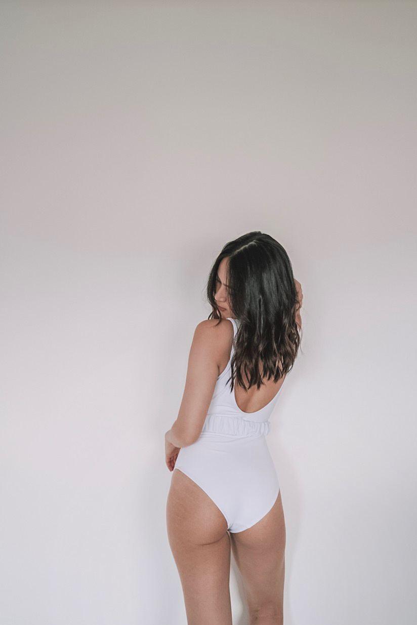 white one-piece swimsuit with belt detail