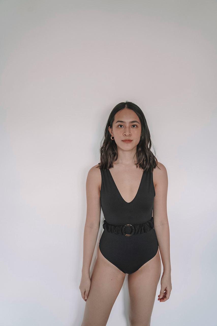 black one-piece swimsuit with belt detail